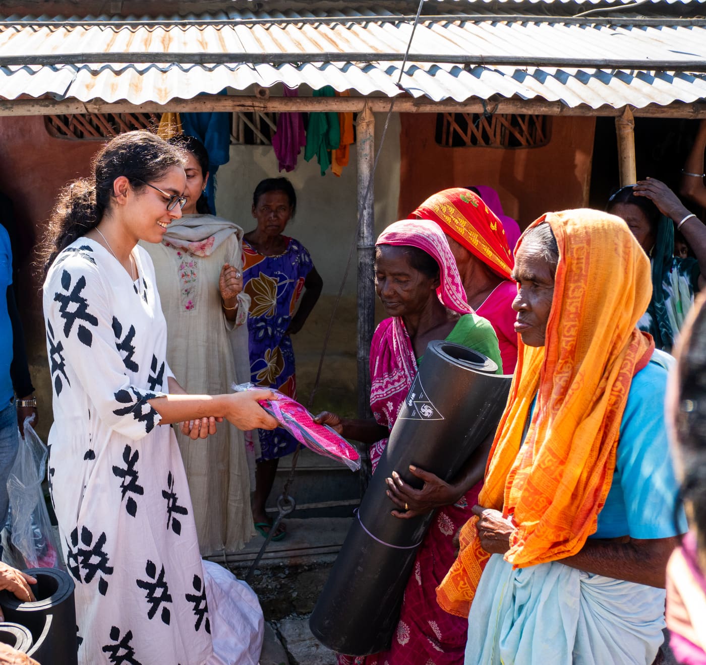 Handing a Saathi mat to a community member